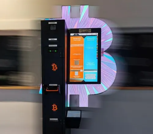 Bitcoin ATM at Bd Carl-Vogt 60 in Geneva with an illuminated purple Bitcoin symbol.