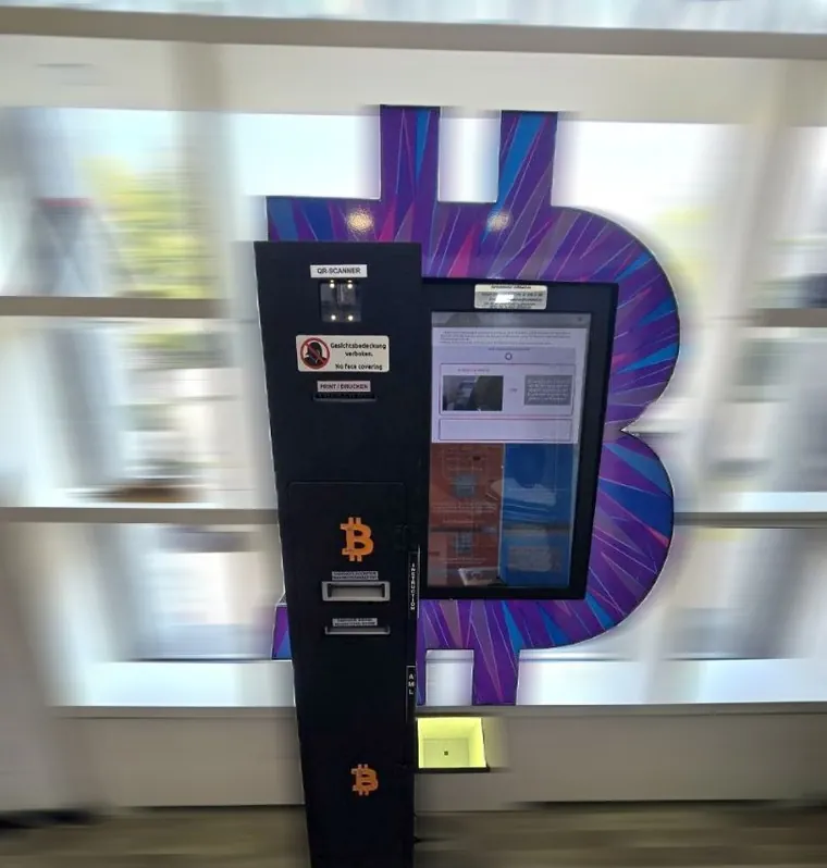 Bitcoin ATM at Merkurstrasse 23 in Winterthur with purple Bitcoin backdrop.